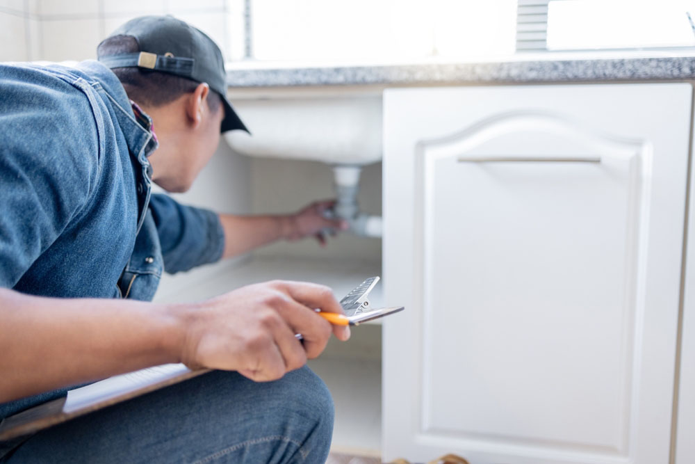 Plumber checking pipe lines